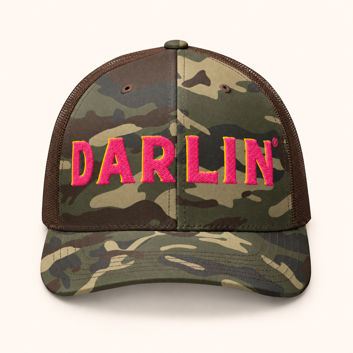 Front view of DARLIN® pink embroidery camo trucker hat with pink and yellow 3D puff embroidery