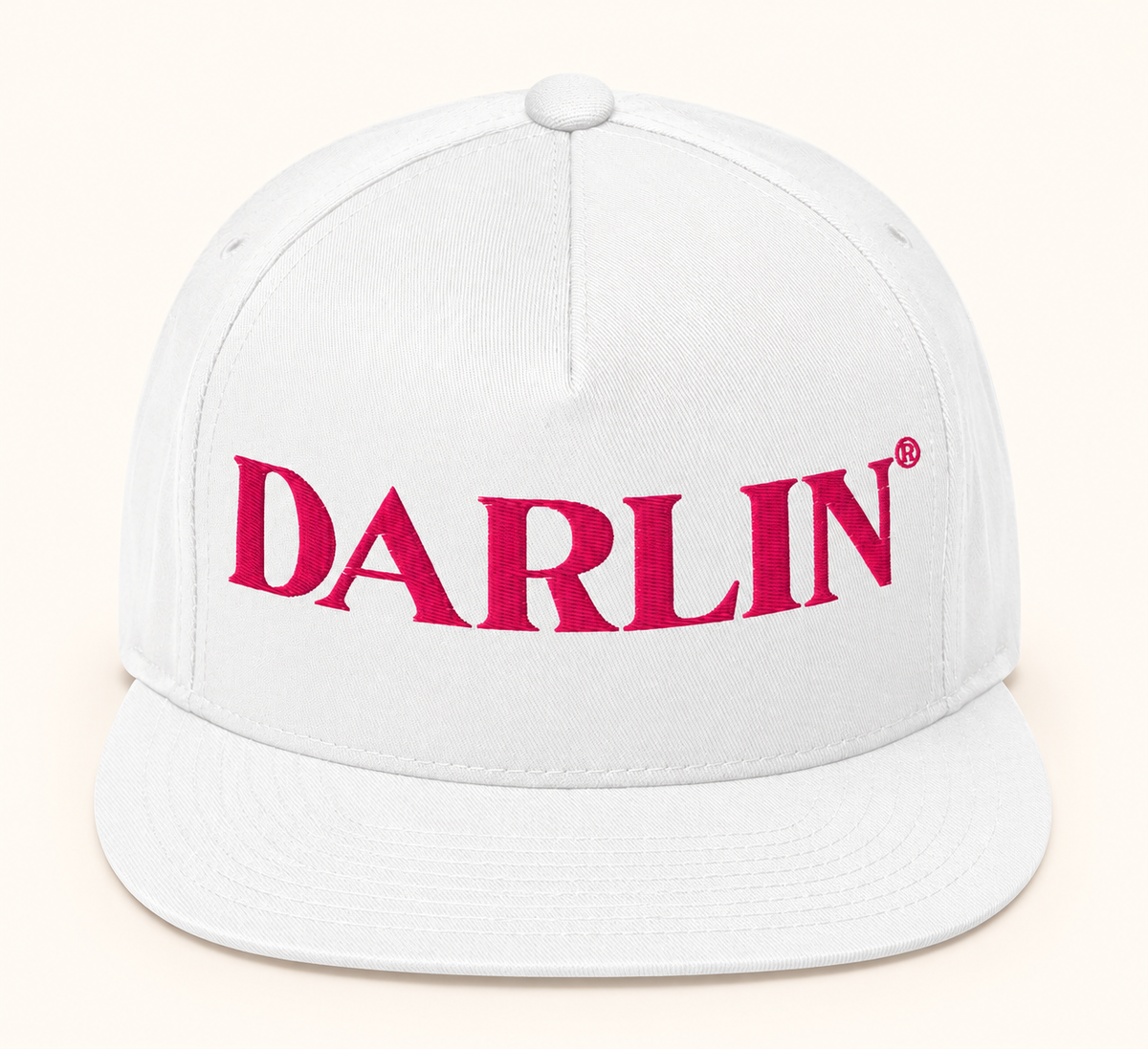 Front view of white DARLIN® snapback hat with bright pink DARLIN® embroidery