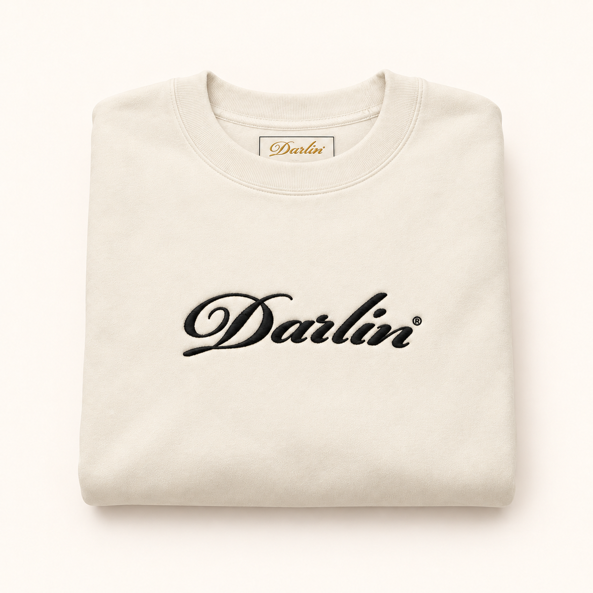 Folded cream DARLIN® crewneck with black embroidered script logo