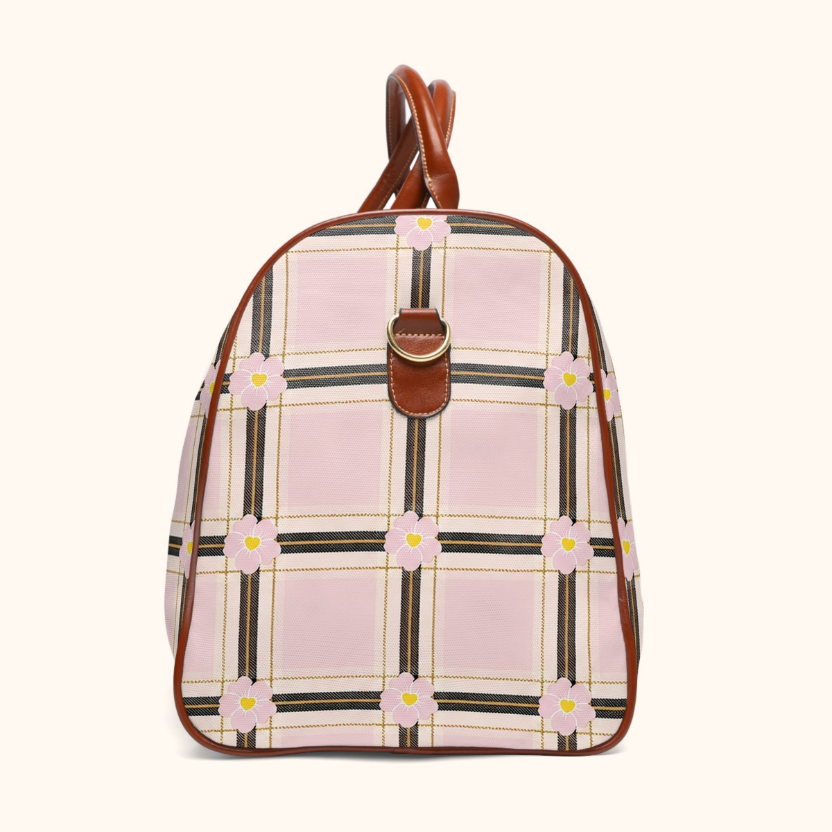 Side view of the DARLIN® Primrose Plaid Weekender showing pink floral plaid, brown trim, and a gold-tone shoulder strap ring on a warm ivory background.