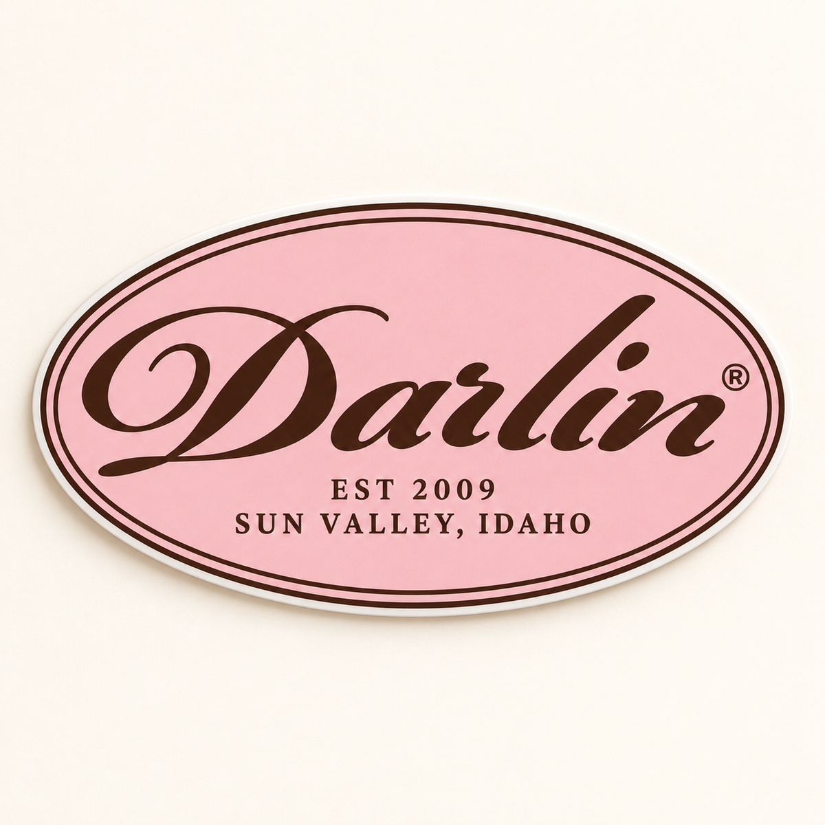 DARLIN® Chocolate Heritage Oval die-cut sticker with Primrose Pink background, Chocolate script, EST 2009, and SUN VALLEY, IDAHO lettering.