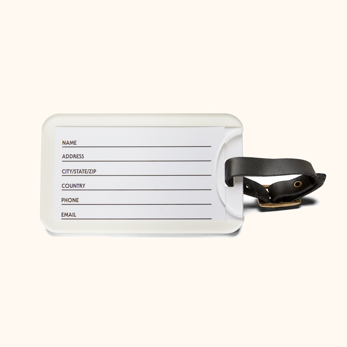 Back of the DARLIN® Primrose Plaid luggage tag showing the contact information card, black strap, and brass buckle on warm ivory.