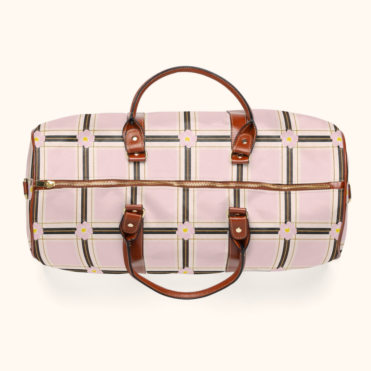 Top view of the DARLIN® Primrose Plaid Weekender showing its gold-colored zipper, brown handles, and pink floral plaid on a warm ivory background.